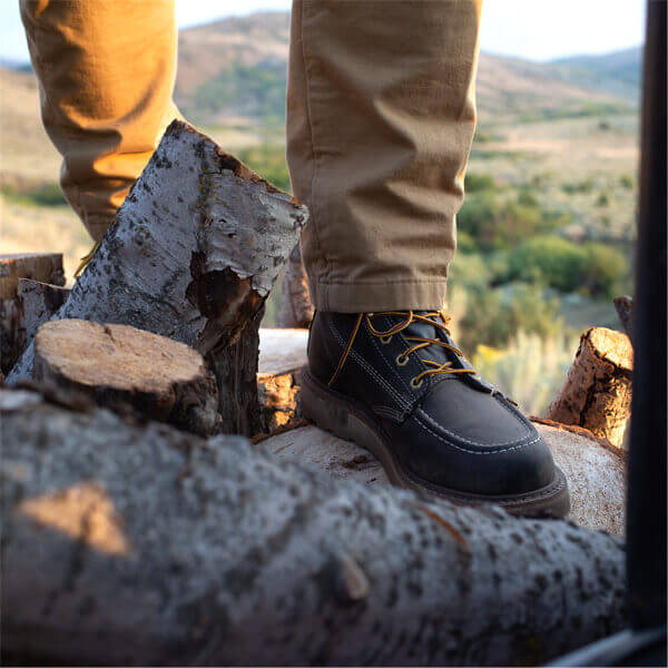 Image of American Heritage 6" black safety toe, moc toe with Maxwear wedge boot on a person