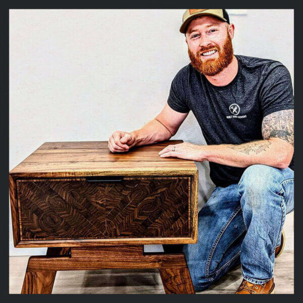 Image of Tanner Zetocha next to one of his wood fine furniture pieces wearing our 4200 boot