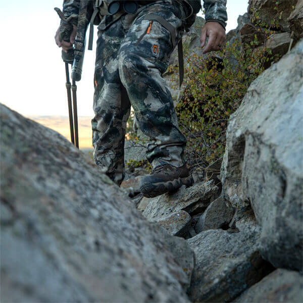 Image of crosstrex series 8" Camo insulated waterproof hiker boot on a person with hunting gear who