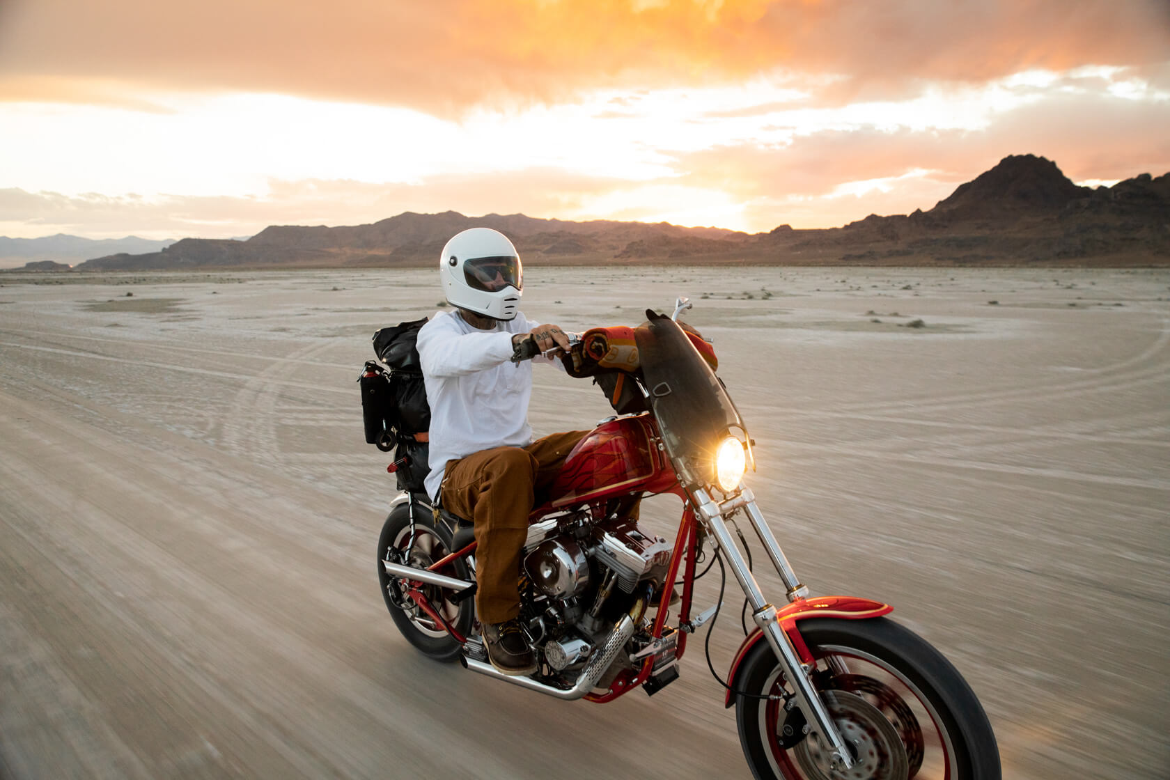 Image of a guy on a motorcycle in the desert