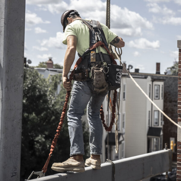 Ironworker wears Thorogood moc toe work boots with Poron comfort cushion insole.