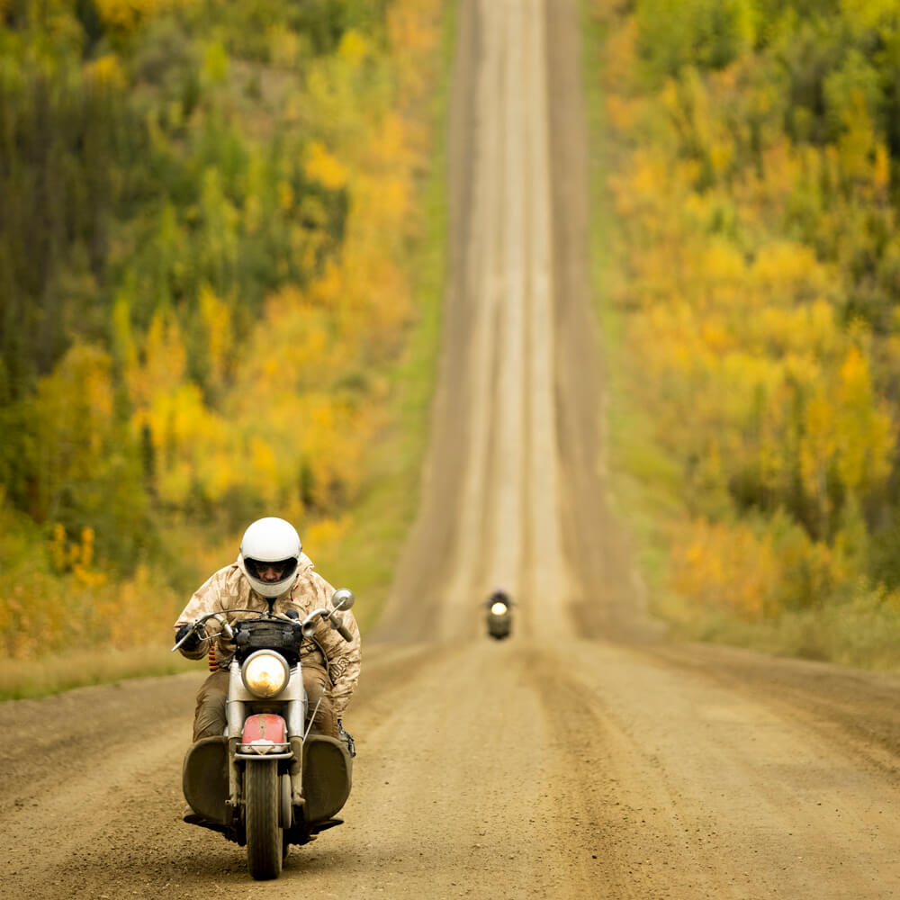 Image of motorcyclist driving up a steep hill