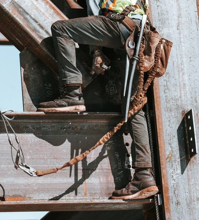 Ironworker wears comfortable work boots with arch support to prevent sore feet.