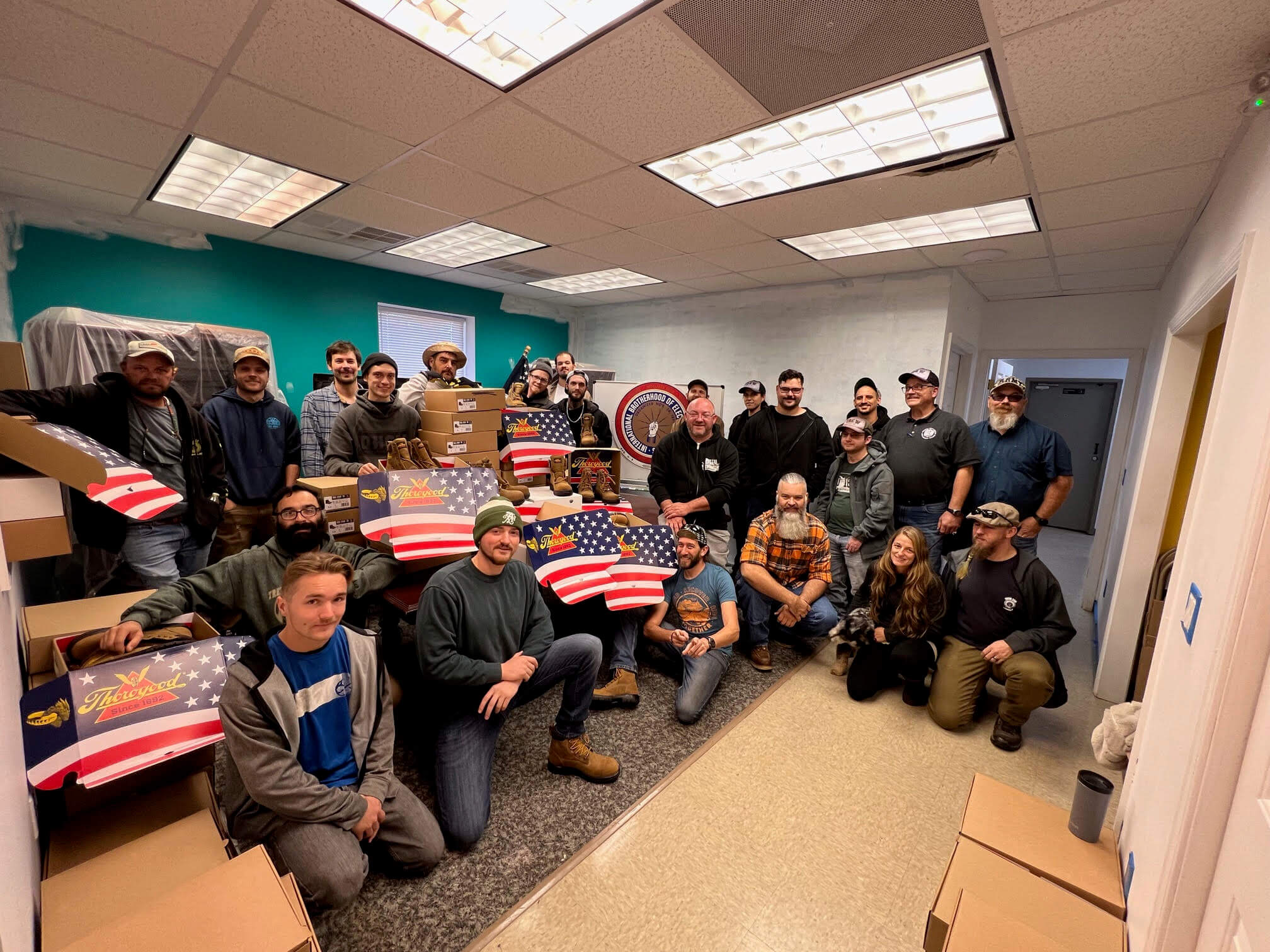 Electrical workers of IBEW Local 238 with work boots donated by Thorogood