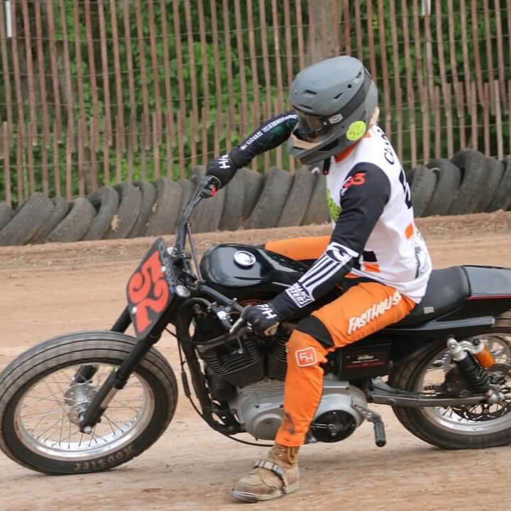 Image of a guy riding a motorcycle on a dirt track
